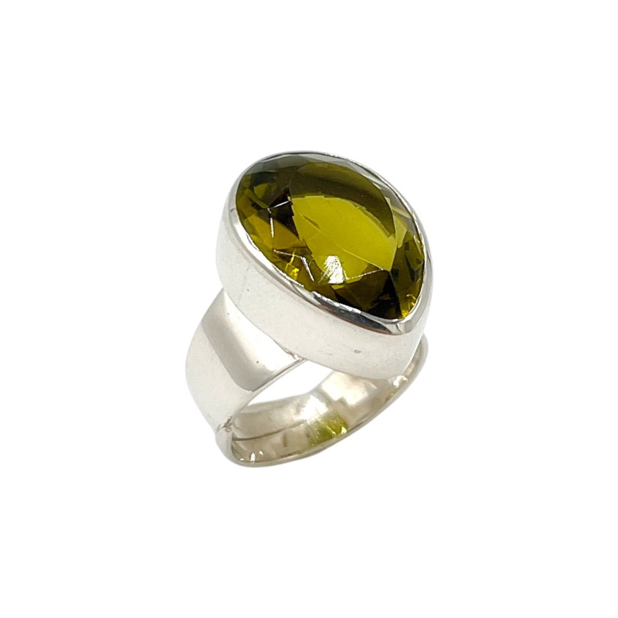 Angled view of golden brown volcanic glass statement ring in polished sterling silver