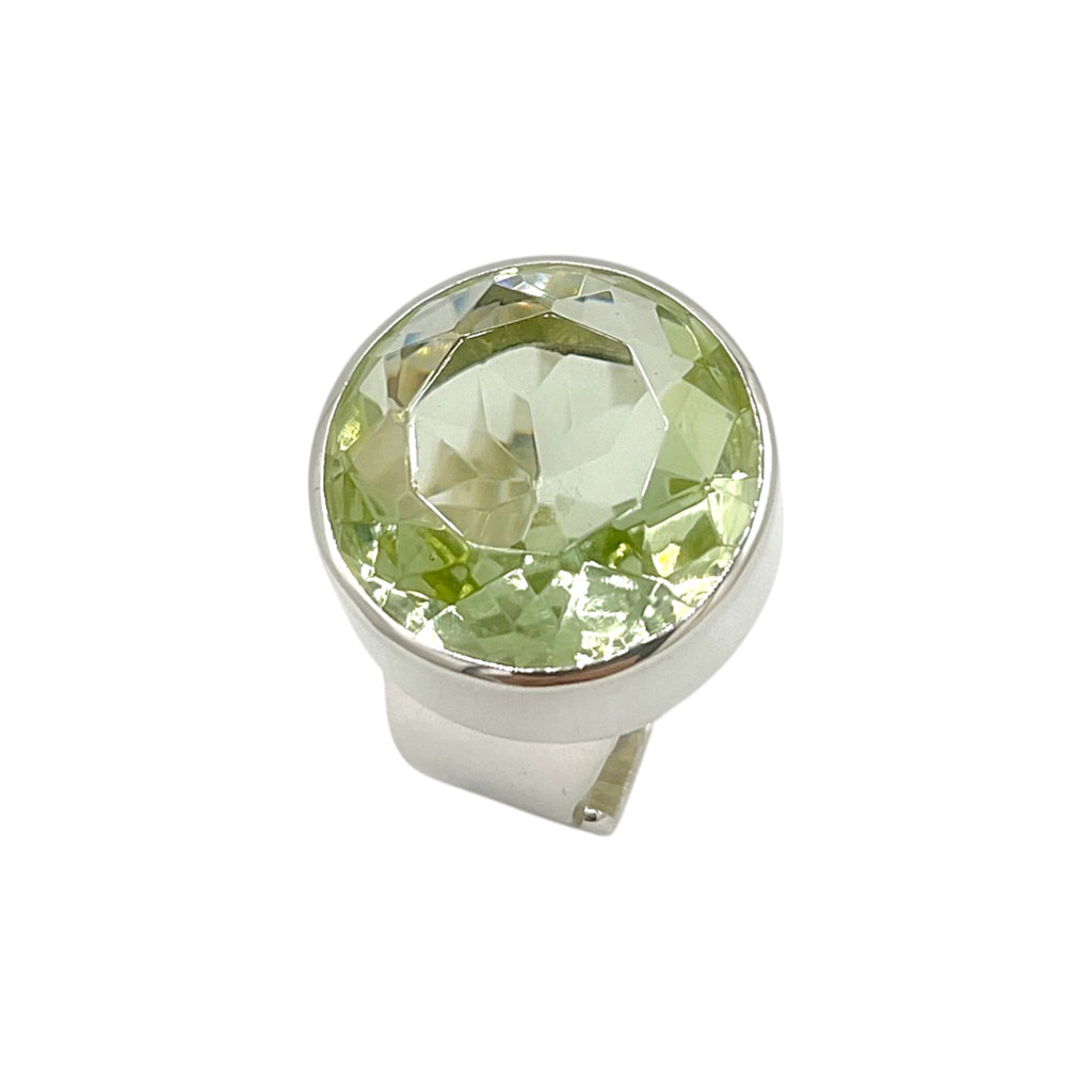 Front close-up of light green faceted volcanic glass ring in polished sterling silver