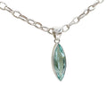 Side view of hand-cut sea blue volcanic glass pendant in polished 925 sterling silver