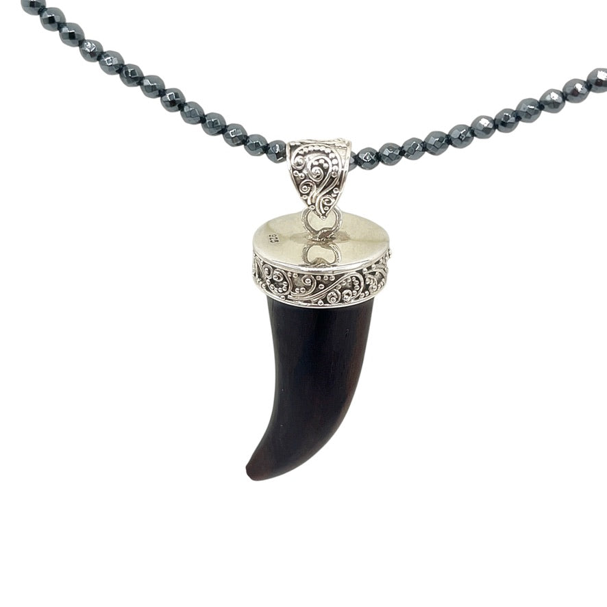 Dark wood curved horn pendant with detailed sterling silver scrollwork
