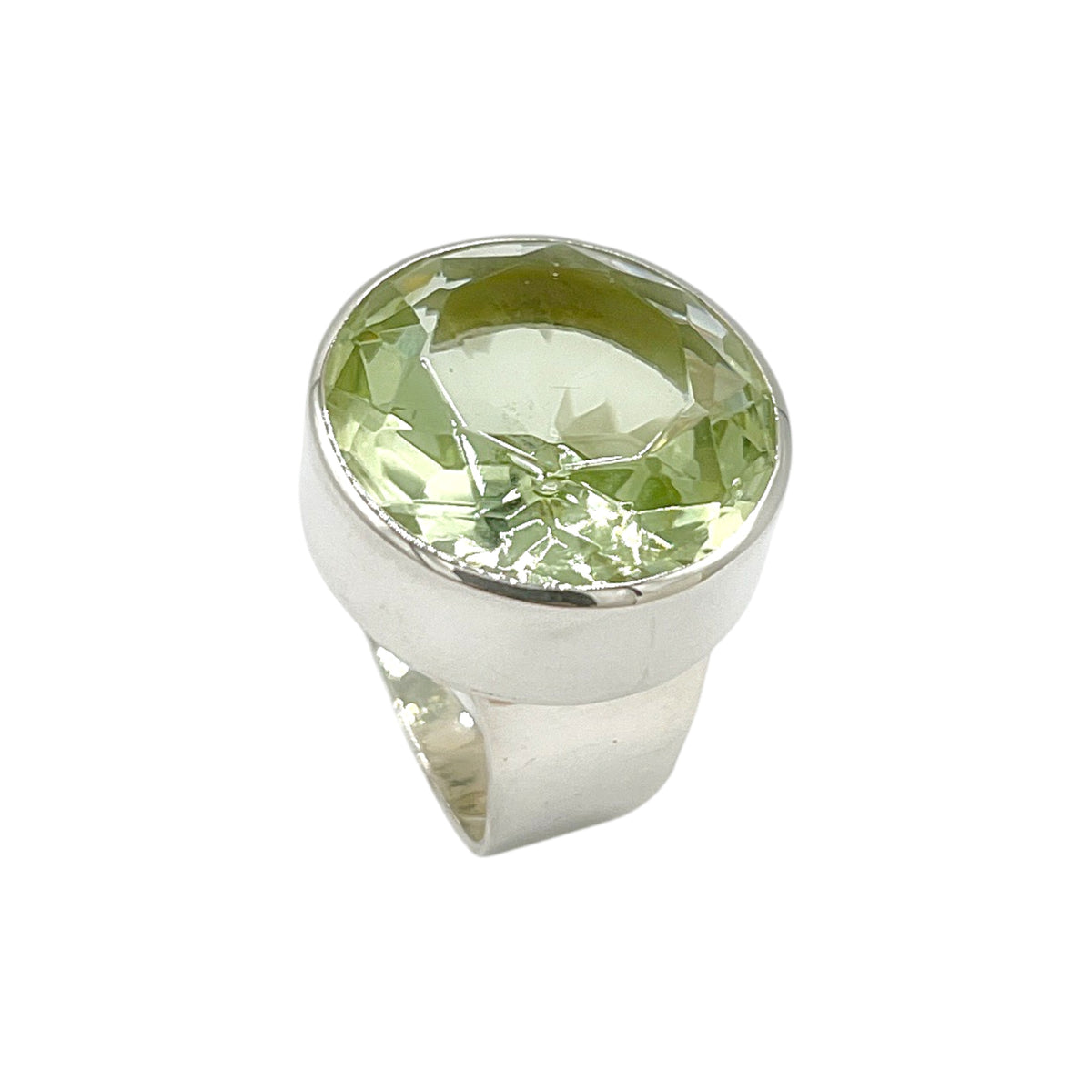 Angled front view of round light green volcanic glass statement ring