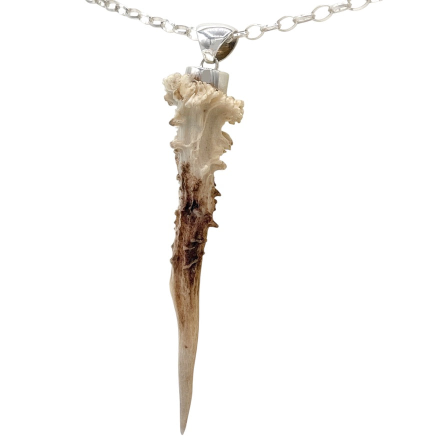 Natural deer antler pendant in 925 sterling silver showing organic surface and pointed shape
