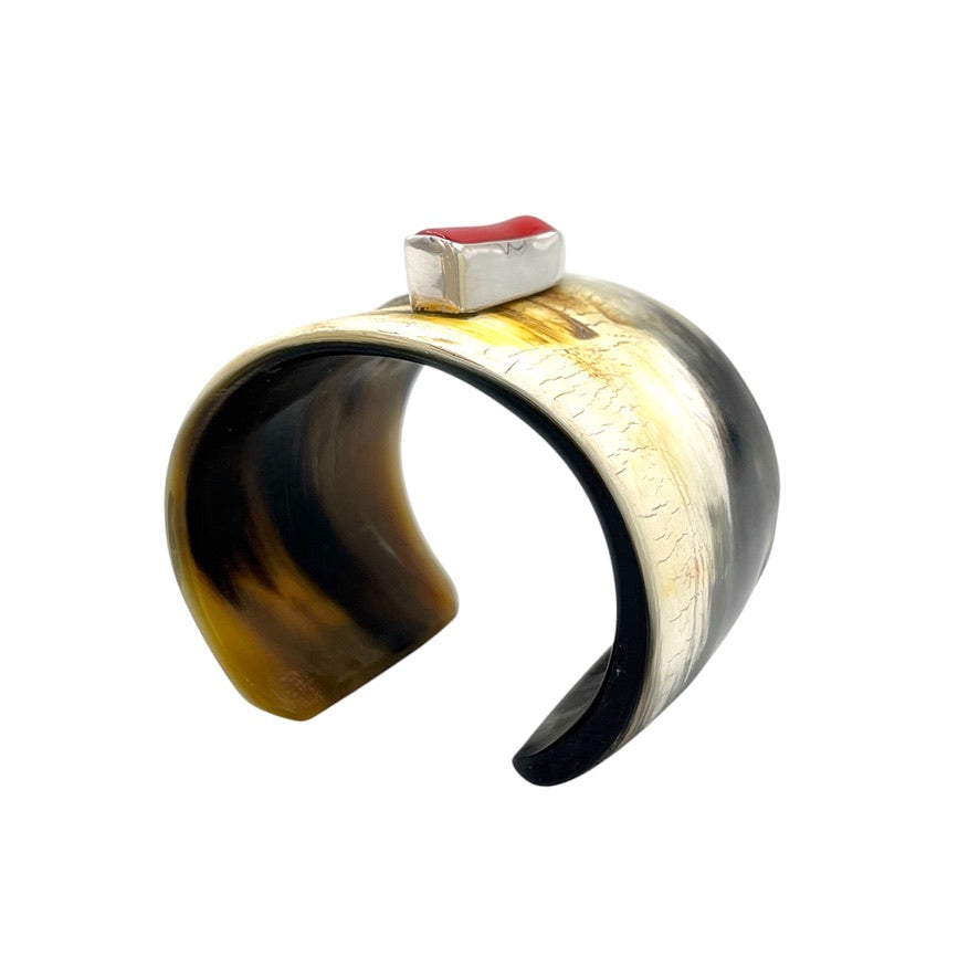 Wide natural buffalo horn cuff bracelet with red branch coral and sterling silver setting, front view